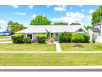 Charming single-story home featuring lush landscaping and a well-manicured lawn at 2637 Debany Rd, Kissimmee, FL 34744