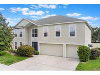Charming two-story home with a spacious three-car garage and beautifully landscaped front yard at 364 Fish Hawk Dr, Winter Haven, FL 33884