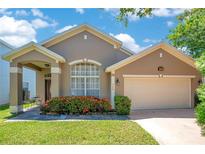 Charming single-Gathering home featuring a well-manicured lawn and a two-car garage at 746 Stonewyk Way, Kissimmee, FL 34744