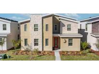 Modern two-story home features stacked stone accents and a vibrant red front door at 9126 Sommerset Hills Dr, Davenport, FL 33896