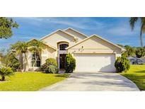 Charming single Gathering home featuring a two-car garage and well-manicured lawn at 1014 Prey Ct, Kissimmee, FL 34746