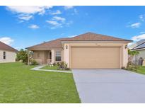 Charming single-story home with a well-manicured lawn and a two-car garage at 1197 E Grove Ave, Lake Wales, FL 33853