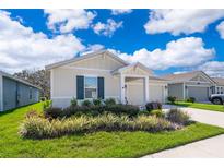 Charming single-story home featuring a well-manicured lawn and inviting curb appeal at 1959 Cricket Cradle Dr, Kissimmee, FL 34746