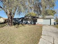 Charming single-story home featuring a well-maintained lawn and mature trees, creating a welcoming curb appeal at 430 Short Dr, Kissimmee, FL 34759