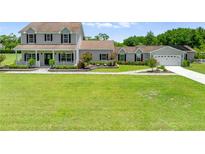 Charming two-story home with a welcoming front porch and lush green lawn at 4551 Hunting Lodge Dr, St Cloud, FL 34772