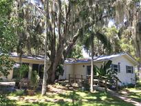 Charming single-story home with a ramp, mature trees, and lush landscaping provides a serene setting at 5019 Pineapple St, Lake Wales, FL 33898