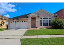 Charming single-story home with a two-car garage and well-maintained lawn at 1730 Sir John Ct, Orlando, FL 32837