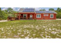 Charming single-story home featuring a solar panel system and a spacious front yard at 2576 R E Byrd Rd, Frostproof, FL 33843