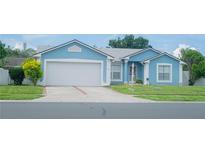 Charming one-story home featuring a well-maintained lawn and an attached two-car garage at 2773 Woodstream Cir, Kissimmee, FL 34743
