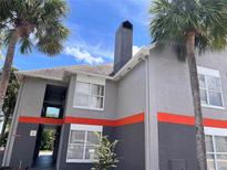 Modern two-story exterior elevation featuring palm trees and gray toned stucco at 3100 Parkway Blvd # 521, Kissimmee, FL 34747