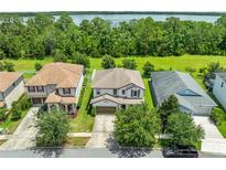 Charming two-story home near the water with mature trees and beautiful landscaping at 3144 Dark Sky Dr, Harmony, FL 34773