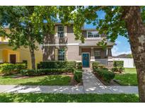 Two story home with a well-manicured lawn and garden, plus a charming blue front door at 3221 Bayflower Ave, Harmony, FL 34773