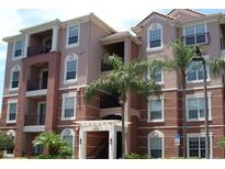 Attractive multi-story condo building with well-maintained facade and tropical landscaping at 4862 Cayview Ave # 40409, Orlando, FL 32819