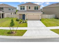Charming two-story home featuring a two-car garage, well-maintained lawn, and inviting curb appeal at 7413 Bent Tree Loop, St Cloud, FL 34771