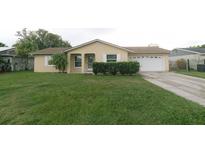 Charming single-story home with a well-maintained lawn and a two-car garage at 956 Florida Pkwy, Kissimmee, FL 34743