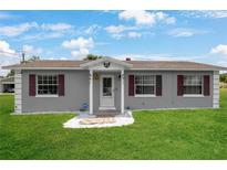 Charming single-story home featuring a well-manicured lawn and decorative stone landscaping at 1 Coyer Rd, Haines City, FL 33844