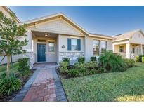 Charming single-Gathering home featuring stone accents, a covered porch, and well-maintained landscaping at 11051 Bostwick Aly, Winter Garden, FL 34787