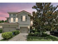 Charming townhome with a brick driveway, attached garage, and well-manicured landscaping for a welcoming curb appeal at 196 Canterbury Bell Dr, Oviedo, FL 32765