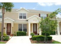 Charming two-story townhome with lush landscaping, a private entrance, and a well-maintained exterior at 2585 Maneshaw Ln, Kissimmee, FL 34747