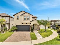 Charming two-story home with a brick driveway and lush landscaping at 2824 Noble Crow Dr, Kissimmee, FL 34744