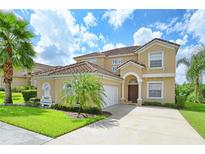 Two-story home with terra cotta roof, attached garage, well-manicured lawn, and ample driveway space at 344 Cherokee Ave, Haines City, FL 33844
