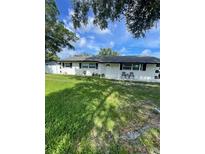 Charming single-story home with a well-maintained lawn and inviting front porch at 400 Vermont Ave, St Cloud, FL 34769