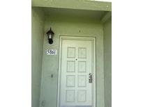 Inviting front door with stylish details and a secure entrance; home address displayed above at 5861 La Costa Dr # 115, Orlando, FL 32807