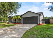 Charming single-story home featuring well-maintained lawn, two-car garage, and beautiful landscaping at 6528 Shepherd Oaks Pass, Lakeland, FL 33811