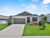 Charming one-story home with a well-manicured lawn and attached two-car garage at 1717 Hilltop Dr, Dundee, FL 33838