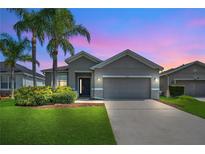 Charming single-story home with a well-manicured lawn and two palm trees in a quiet neighborhood at 2663 Youngford St, Orlando, FL 32824