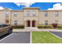 Inviting townhome with manicured landscaping, neutral paint, and convenient parking at 2855 Club Cortile Cir, Kissimmee, FL 34746