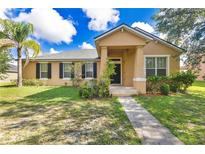 Inviting single-story home featuring a well-manicured lawn, covered entryway, and classic window shutters at 3125 Grasmere View Pkwy, Kissimmee, FL 34746