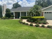 Charming single-story home with a well-manicured lawn and lush landscaping at 3715 Sarasota Ct, Orlando, FL 32812