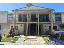 Inviting condo featuring balconies and a staircase leading to the upper levels, offering a blend of comfort and style at 5967 Village Cir # Ge, Orlando, FL 32822