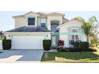 Charming two-story home with a well-manicured lawn and attached two-car garage at 7912 Golden Pond Cir, Kissimmee, FL 34747