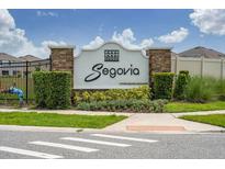 Stone and stucco sign for Segovia, A Park Square Community with manicured landscaping at 2740 Picasso Ct, Kissimmee, FL 34743