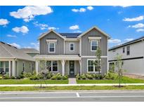 Charming two-story home with a well-manicured lawn and inviting front porch at 3026 Prospect Trl, St Cloud, FL 34771