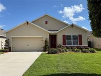 Charming single-Gathering home featuring a well-manicured lawn and tasteful landscaping at 306 Briar Patch Loop, Davenport, FL 33896