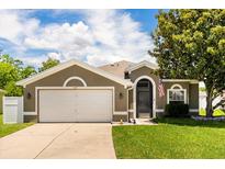 Charming single Gathering home with a well manicured lawn and a two car garage at 3217 Whooping Crane Run, Kissimmee, FL 34741