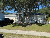 Charming single-Gathering home featuring an attached garage, beautiful landscaping, and a well-manicured lawn at 478 Acacia Tree Way, Kissimmee, FL 34758
