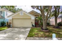 Inviting one story home featuring manicured lawn, mature trees, and charming curb appeal at 10934 Rushwood Way, Clermont, FL 34714