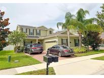 Charming two-story home with manicured lawn and a paved driveway fitting two parked cars at 15230 Evergreen Oak Loop, Winter Garden, FL 34787