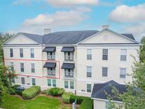 Spacious multi-story building with black awnings and well-maintained landscaping, perfect for comfortable living at 193 Longview Ave # 203, Celebration, FL 34747