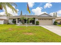 Charming single-story home with well-maintained lawn, brick accents, and a welcoming two-car garage at 2569 Tandori Cir, Orlando, FL 32837