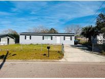 Charming home with a well-maintained front yard, featuring a driveway and tasteful landscaping at 329 N Hart Blvd, Orlando, FL 32835