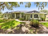 Charming single-story home with manicured lawn and lush landscaping at 5204 Hammock Pointe Ct, St Cloud, FL 34771