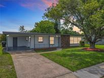 Charming single-story home featuring a well-manicured lawn and a brick accent wall at 5312 Kingswood Dr, Orlando, FL 32810