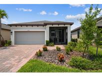 Charming single-story home with a screened porch, paver driveway, and well-maintained landscaping at 1309 Lombardi Ct, Kissimmee, FL 34759