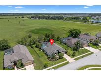 Gorgeous aerial view of the home and pool, backing onto expansive green space at 1525 Gants Cir, Kissimmee, FL 34744
