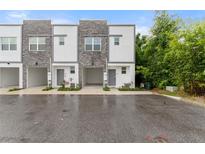 Modern townhome exterior showcases a stylish facade and convenient attached garage at 236 Famagusta Dr, Davenport, FL 33896